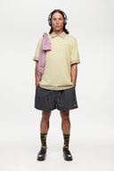 Yellow polo shirt with checkered collar and sleeves
